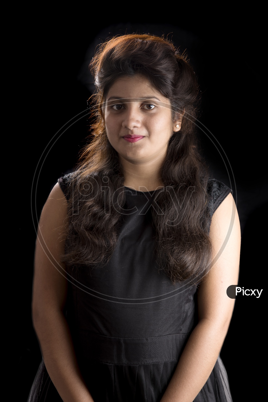 Portrait of a Pretty Young Woman  With Smile Face and Posing Over am Isolated B;lack  Background