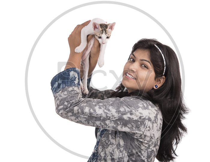 Portrait of a Pretty Young Woman  With Smile Face Holding a Cat in Hand  and Posing Over am Isolated White Background