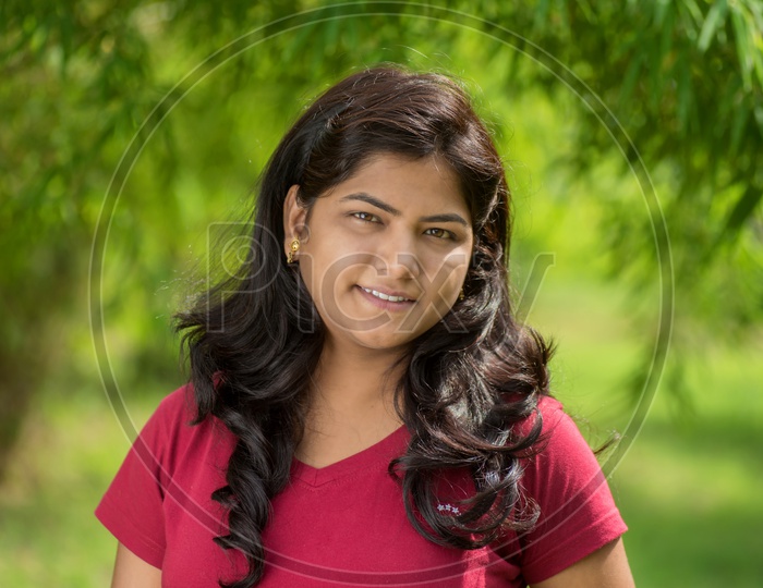Portrait Of a Young Indian Beautiful Woman Posing In Outdoor Or In a Park Background