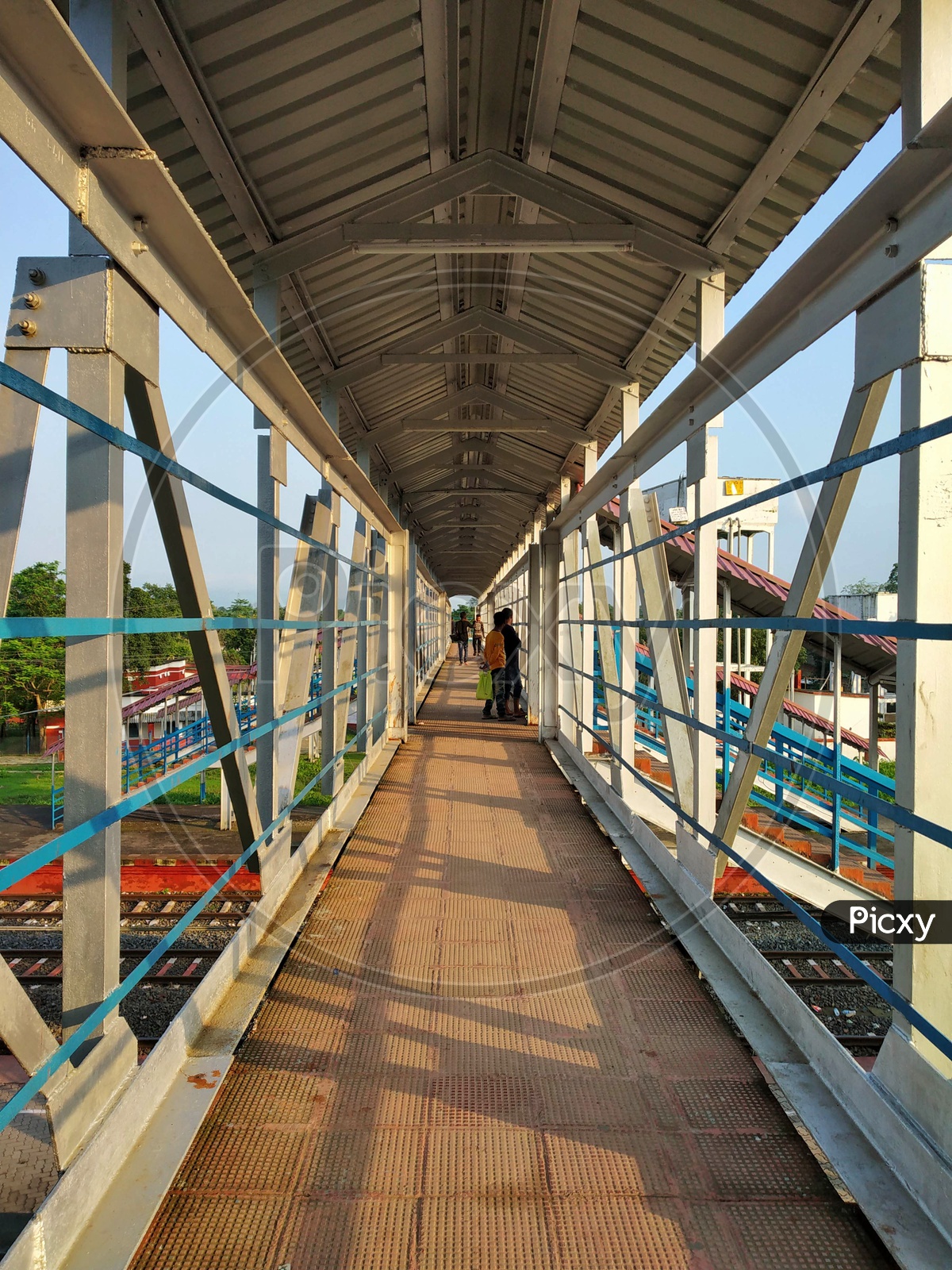 Passengers On Foot over  Bridge With Luggage Bags in a Railway Station