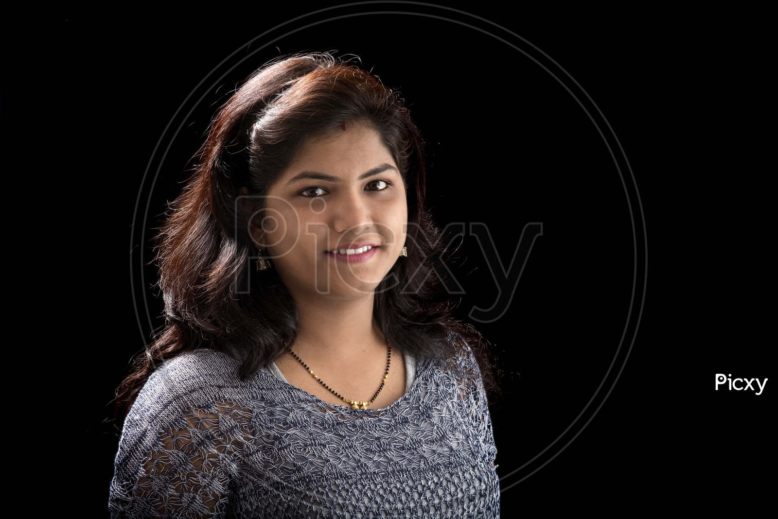 Portrait of a Pretty Young Woman  With Smile Face and Posing Over am Isolated B;lack  Background
