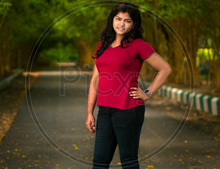 Image of Portrait Of a Young Indian Beautiful Woman Posing In Outdoor Or In  a Park Background-JE204081-Picxy