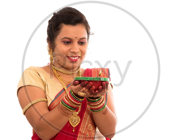 A Traditional Indian Woman  Holding Diwali Diya In Hand  On an Isolated White Background