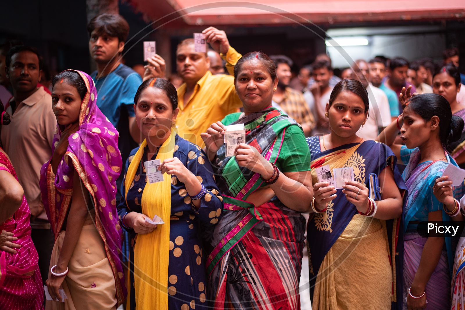 Woman Voters in Queue Lines And Showing The Voter Id Cards to Cast Their Votes for Lok Sabha General Elections 2019 in West Bengal