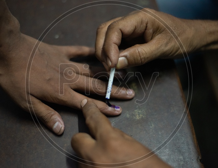 Election Booth Officers Inking The Voters Fingers At Polling Stations