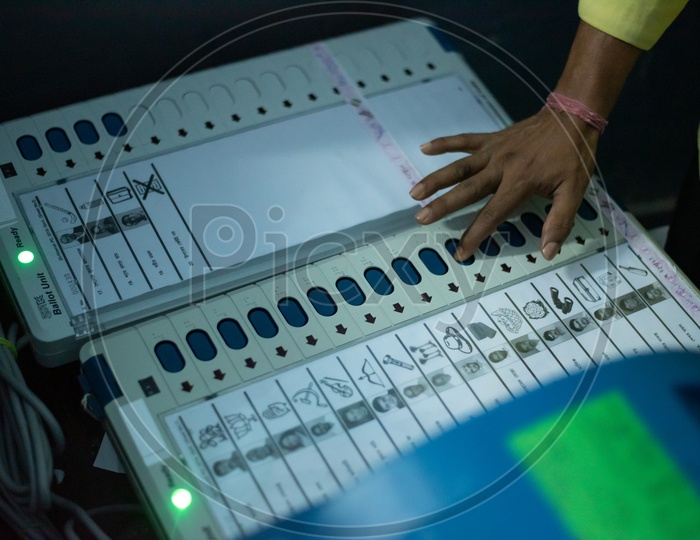 Voters Using Electronic Voting Machines ( EVM ) In a Polling Booth  For Voting In Lok Sabha General Elections 2019