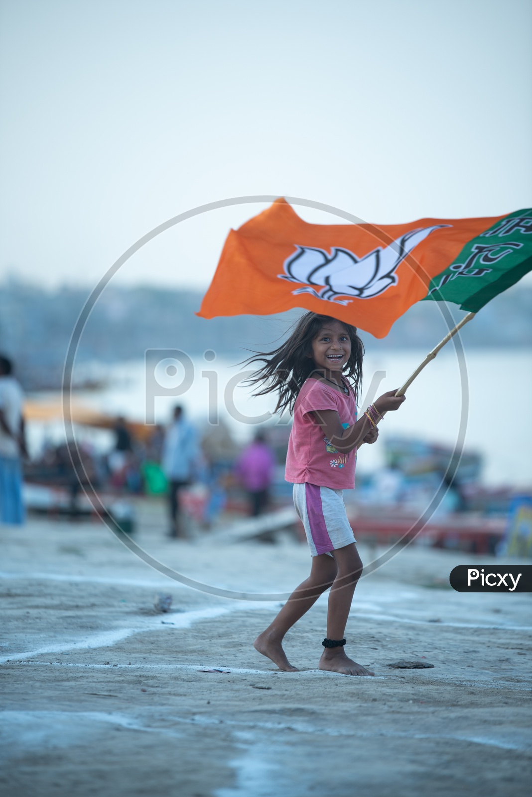 A Small Girl Waving  BJP Party Flag in Varanasi On Election Day