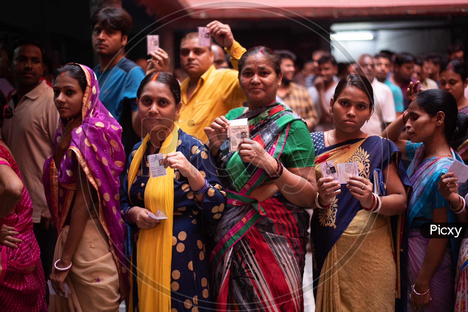 Woman Voters in Queue Lines And Showing The Voter Id Cards to Cast Their Votes for Lok Sabha General Elections 2019 in West Bengal