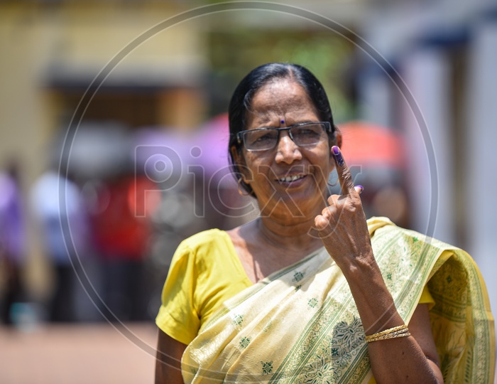 An Indian woman Showing The Inked Finger After Casting Her Vote In Lok Sabha General Elections  2019 in West Bengal
