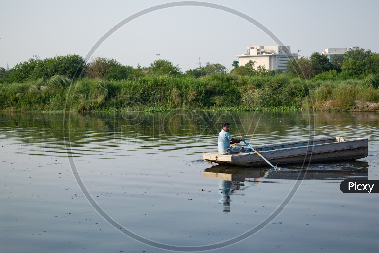 A man sailing a boat in the Yamuna river, Delhi