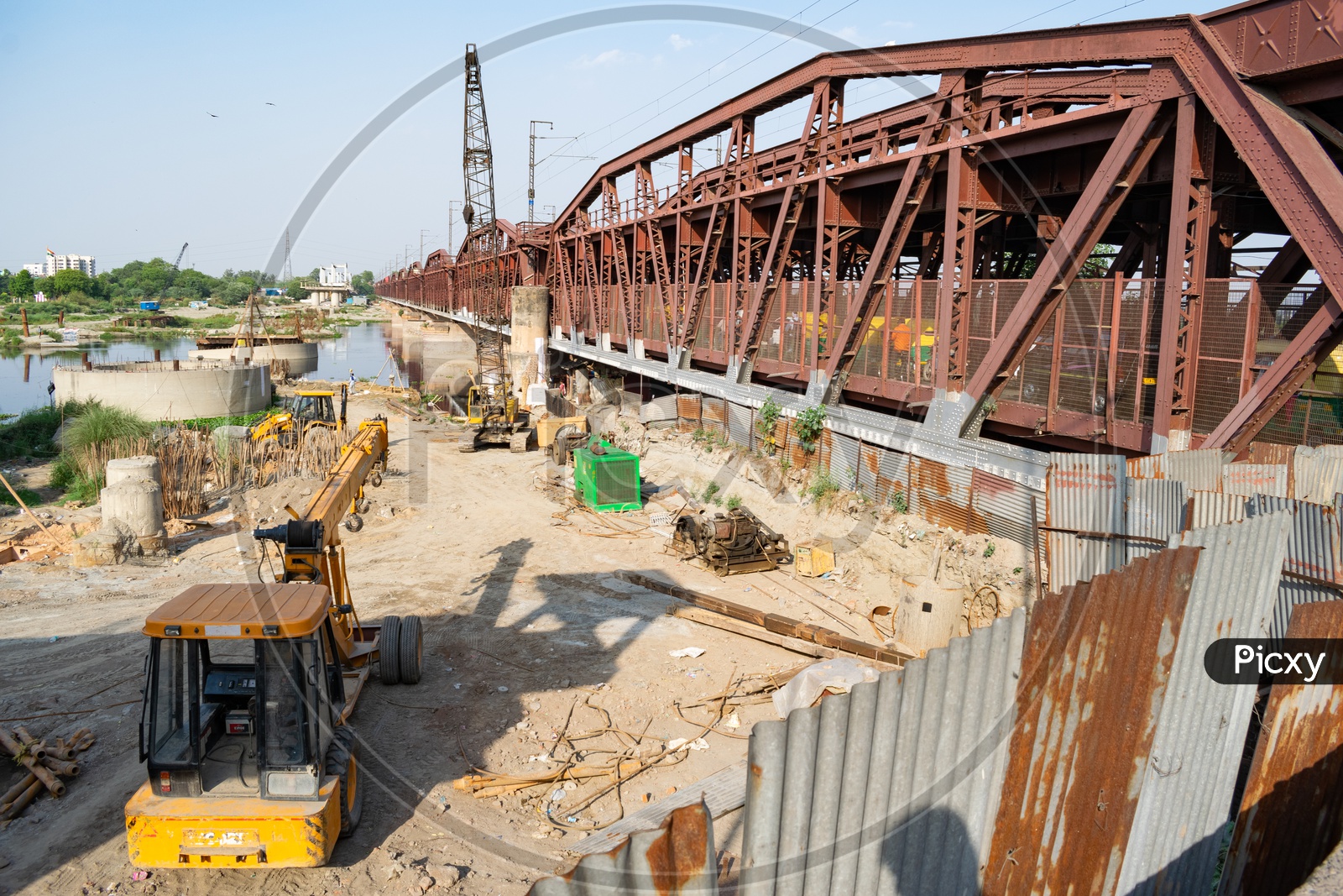 Crane machines and JCB during construction of rail bridge at Delhi