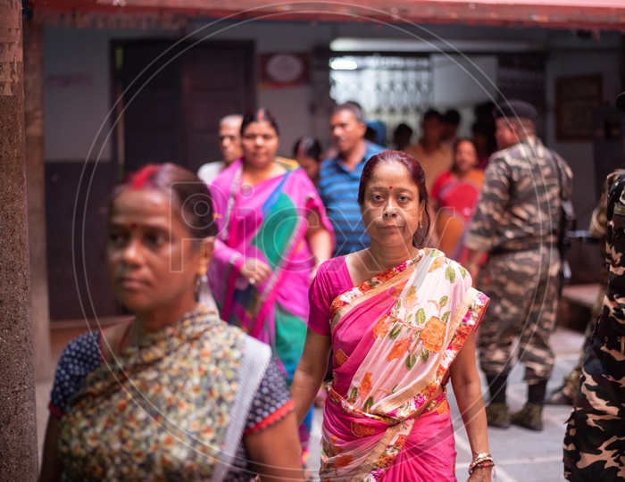 Woman Voters in Queue Lines To Cast Their Vote at a  Polling Station