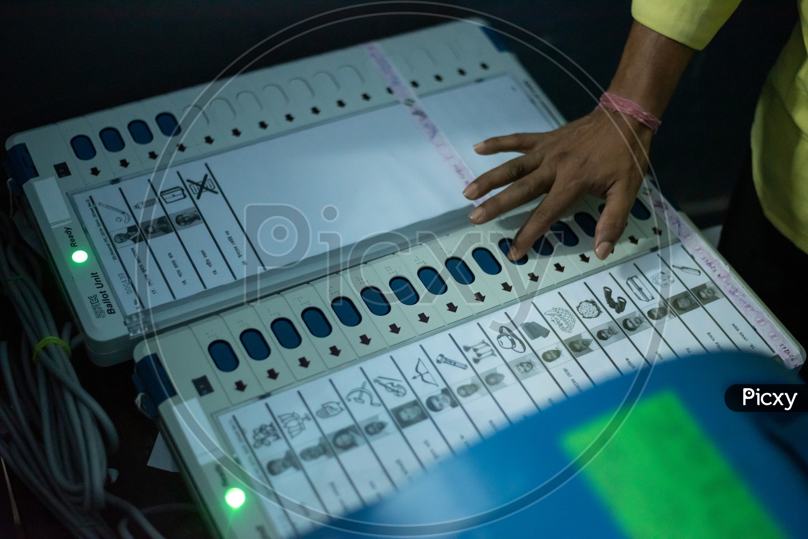 Voters Using Electronic Voting Machines ( EVM ) In a Polling Booth  For Voting In Lok Sabha General Elections 2019
