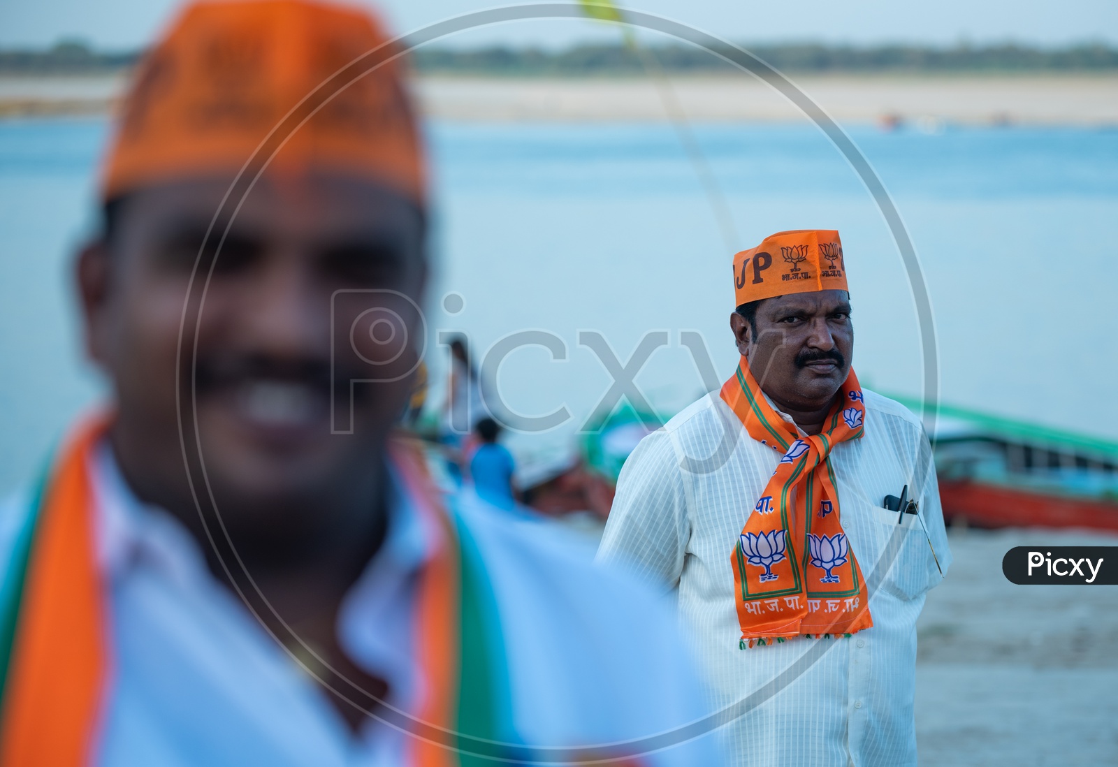 BJP Party Workers Or Supporters Wearing Party Caps And Towels In Election Campaigns