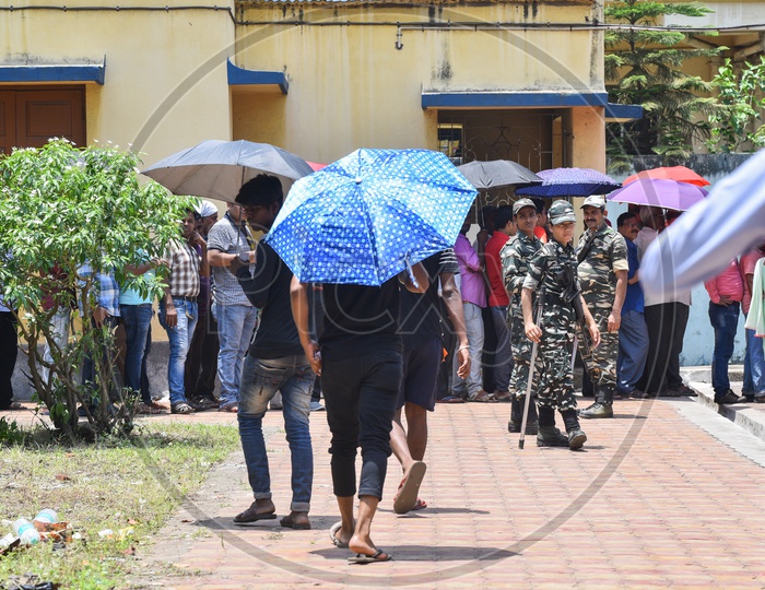 Voters Carrying The Umbrellas  To Take Shade From Bright Sun at  Polling Stations During The Lok Sabha General Elections  2019