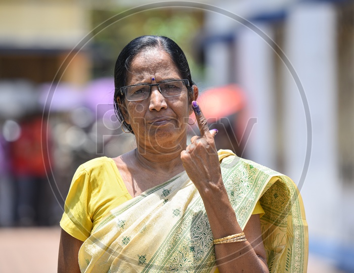 An Indian woman Showing The Inked Finger After Casting Her Vote In Lok Sabha General Elections  2019 in West Bengal