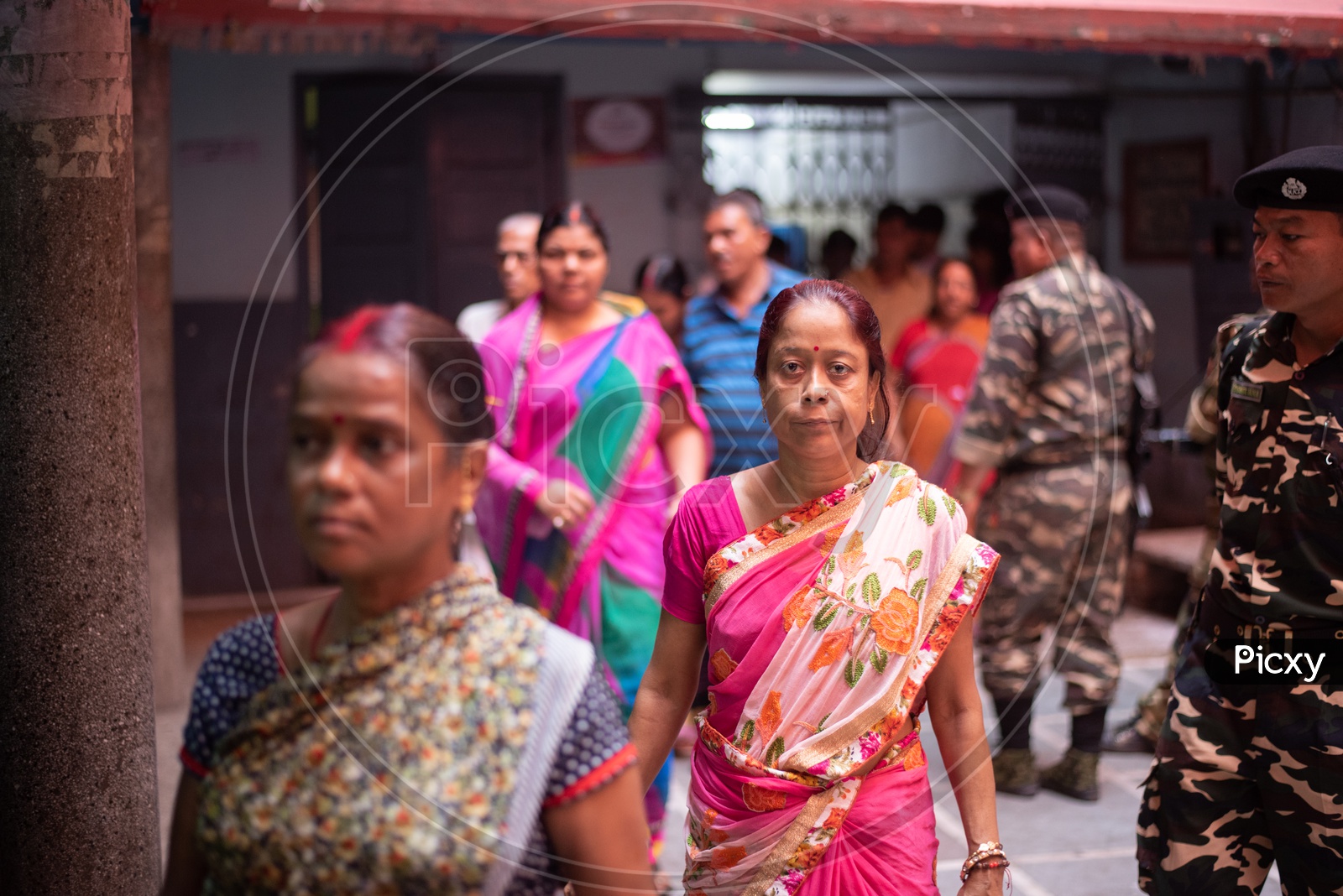 Woman Voters in Queue Lines To Cast Their Vote at a  Polling Station