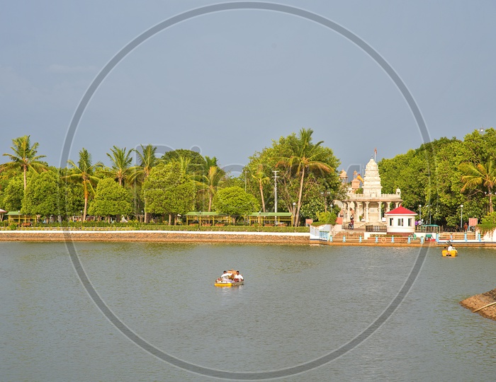 Tourists At Water Front Boat Cycling at Anand Sagar Temple
