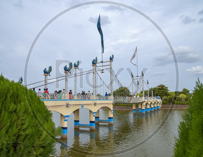 Tourists Enjoying At a Bridge Over Water in Anand Sagar Temple , Shegaon