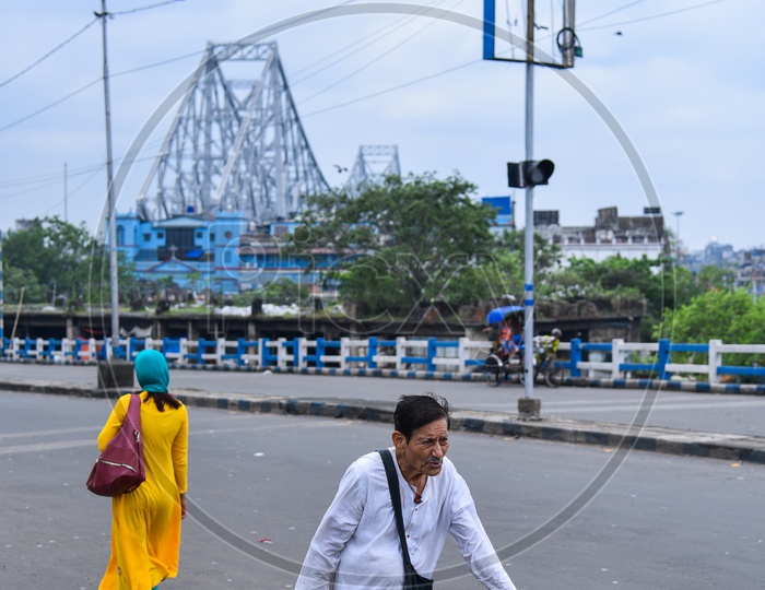 An Old man walking along The Road  in Kolkata