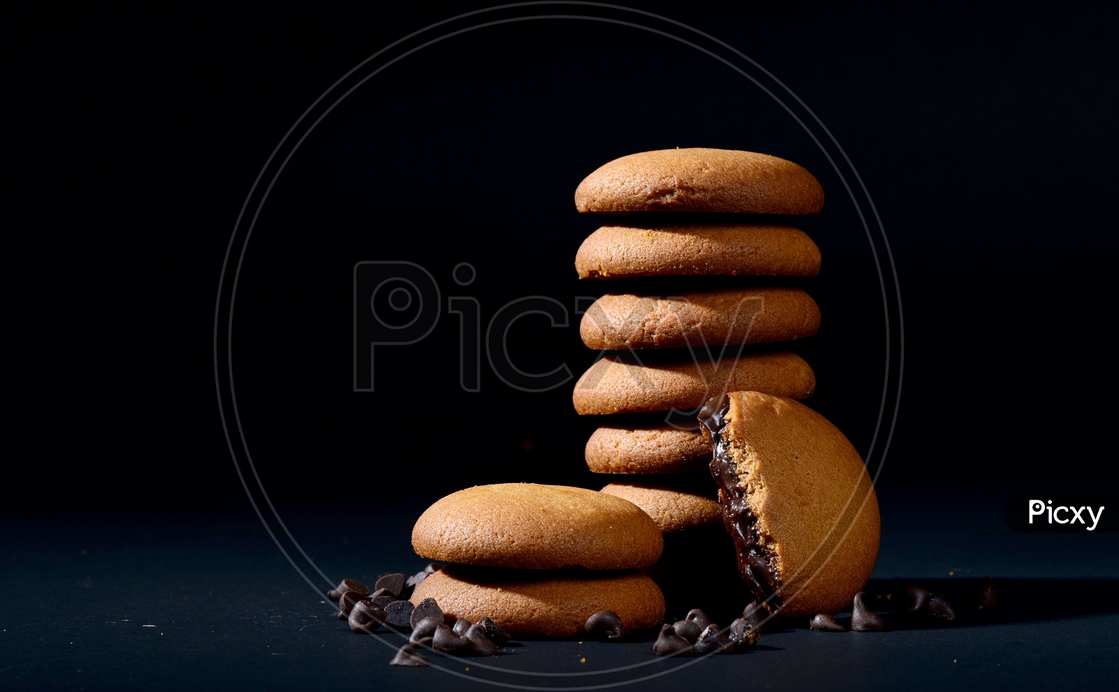 BISCUITS - Stack of delicious cream biscuits filled with chocolate cream on black background