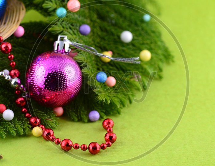 Christmas Decoration Balls With Christmas Tree Branch Forming a Background For Christmas Wishes