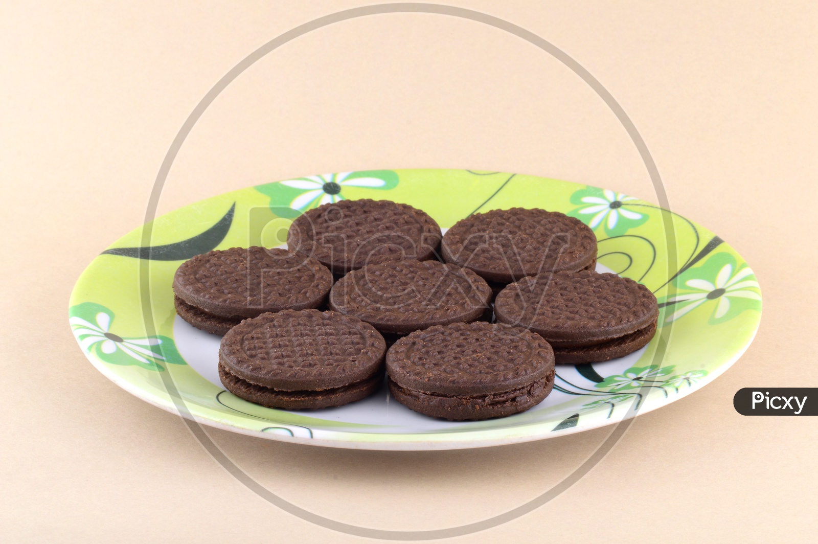Brown chocolate sandwich biscuits with cream filling in plate