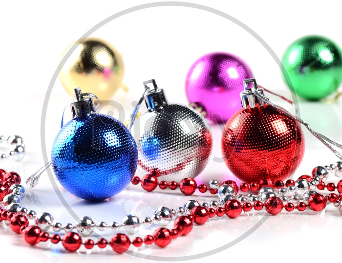 Christmas Tree Decoration Balls, Ornaments and Chains on an Isolated White Background