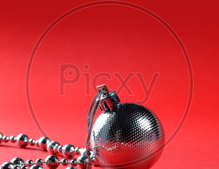 Christmas Tree Decoration Balls, Ornaments  And Chains on an Isolated Red   Background
