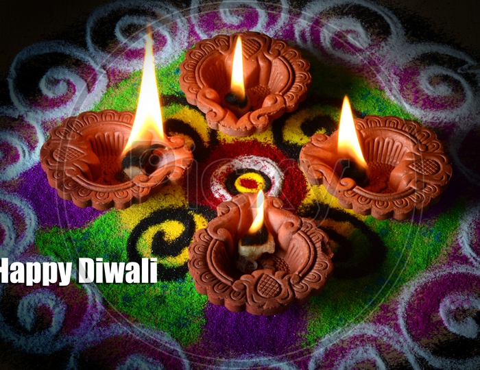 Indian Festival Diwali Clay Diyas In Colorful Rangoli