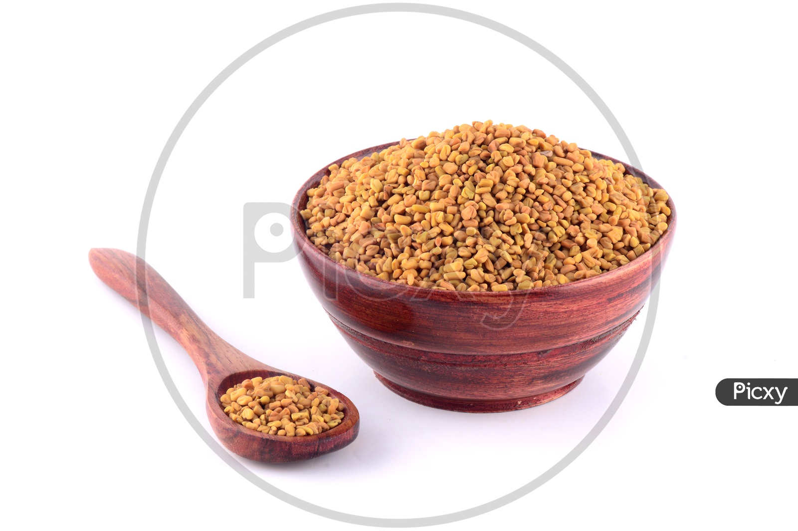 Fenugreek seeds in wooden bowl and spoon isolated on white background