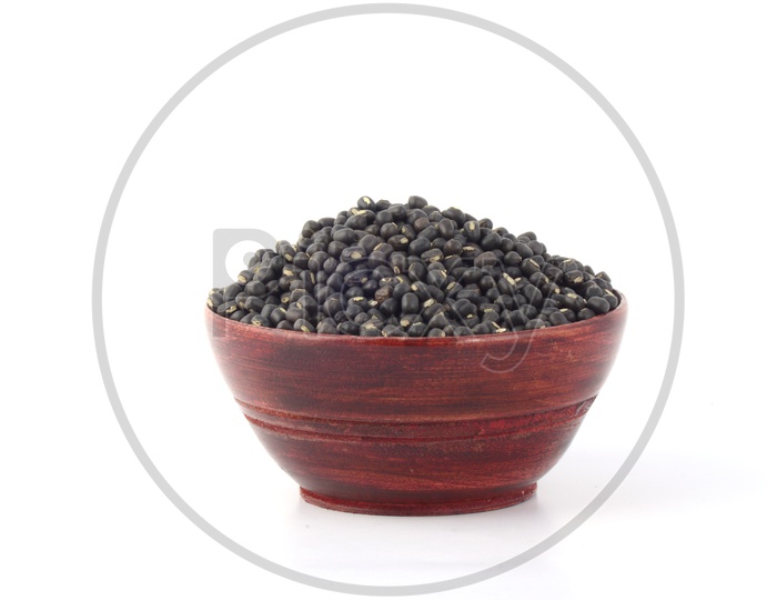 Urad dal, black gram, Vigna mungo in a Wooden  Pot on An Isolated  white background