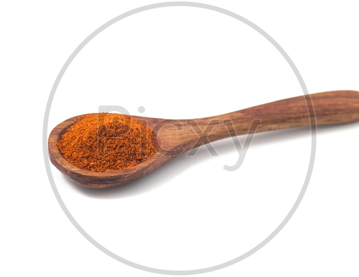 paprika powder spices on spoons isolated on a white background