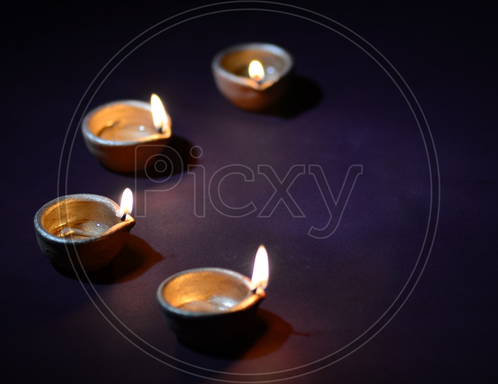Indian Festival Diwali Clay Diyas on An Isolated Background For Diwali Greetings or Wishes Templates