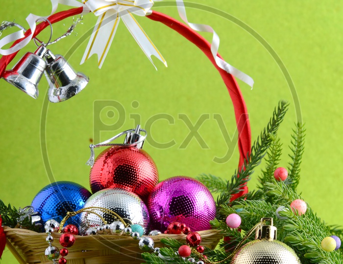 Christmas Decoration Color Balls And  Ornaments And A Branch Of Christmas Tree On in a  Basket For Christmas Wishes