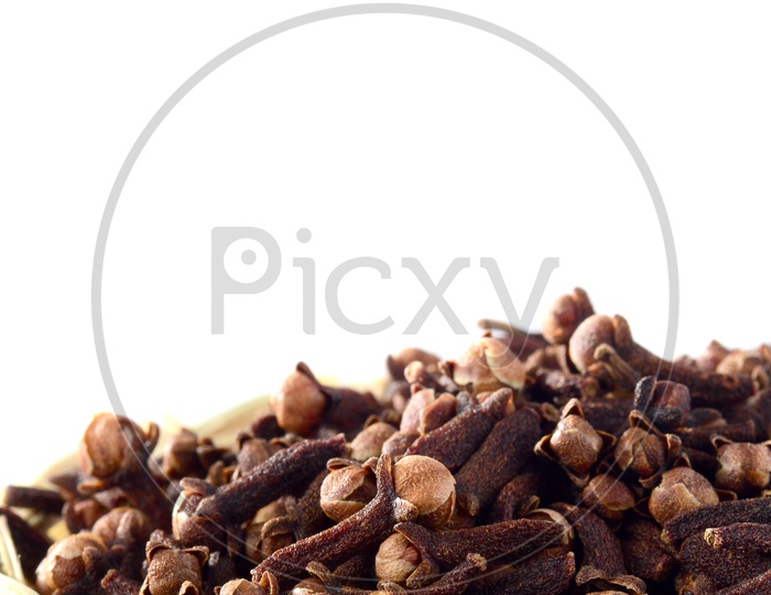 Cloves Or Indian Spice Cloves in a Wooden Weaved Basket  On An Isolated White Background