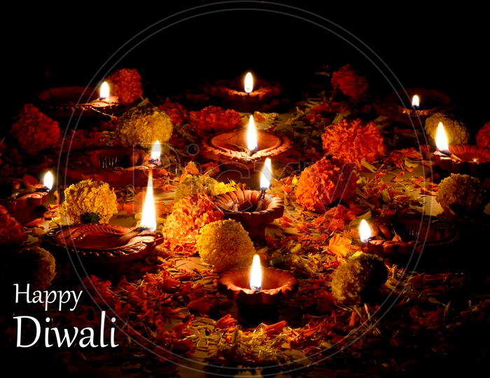 Indian Hindu God Pooja On a Festival With Clay Diwali Diyas And Flowers Template For Festival Wishes or Greetings