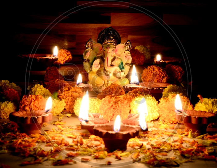Indian Hindu God Pooja On a Festival With Clay Diwali Diyas And Flowers Template For Festival Wishes or Greetings
