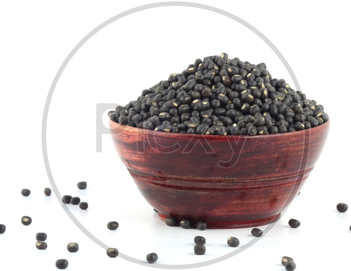 Urad dal, black gram, Vigna mungo  In wooden Bowl on  An Isolated white background