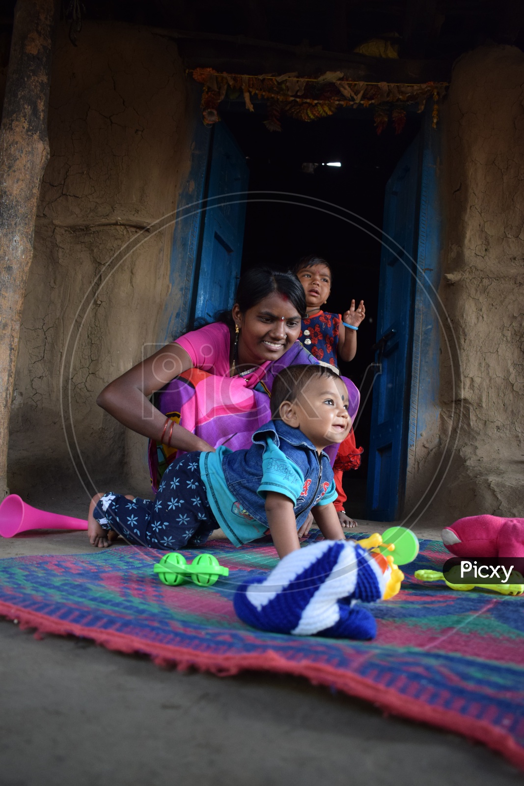A Small Child And Mother In A  Tribal Village  House  Happily  Smiling