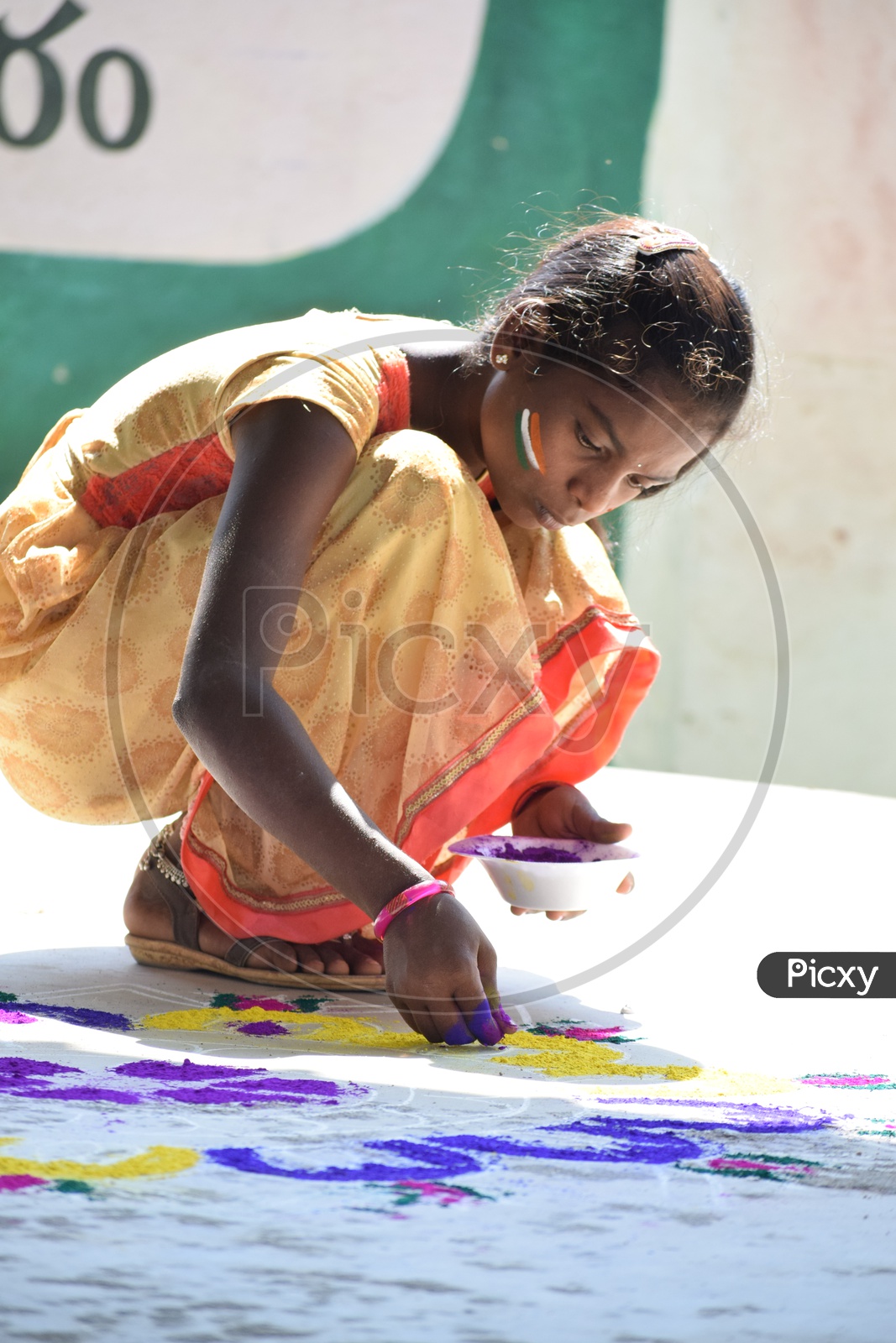 An Indian Girl Making Rangoli  In an Event
