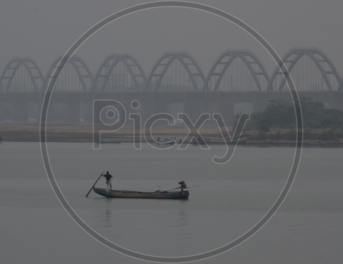 Fisherman Boats In The Goadavari River  At Godavari Bridge In a Foggy Morning