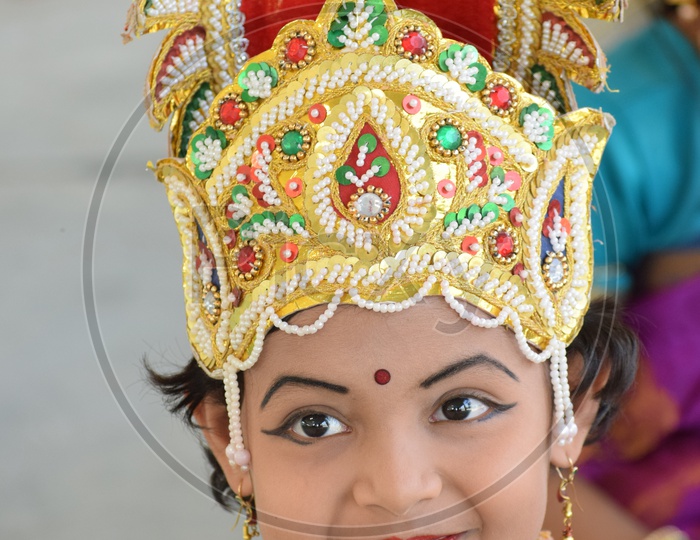 A Girl Wearing a Crown and Smiling In an Event