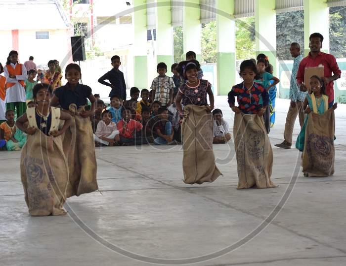 School Children Participating in a Sack Race