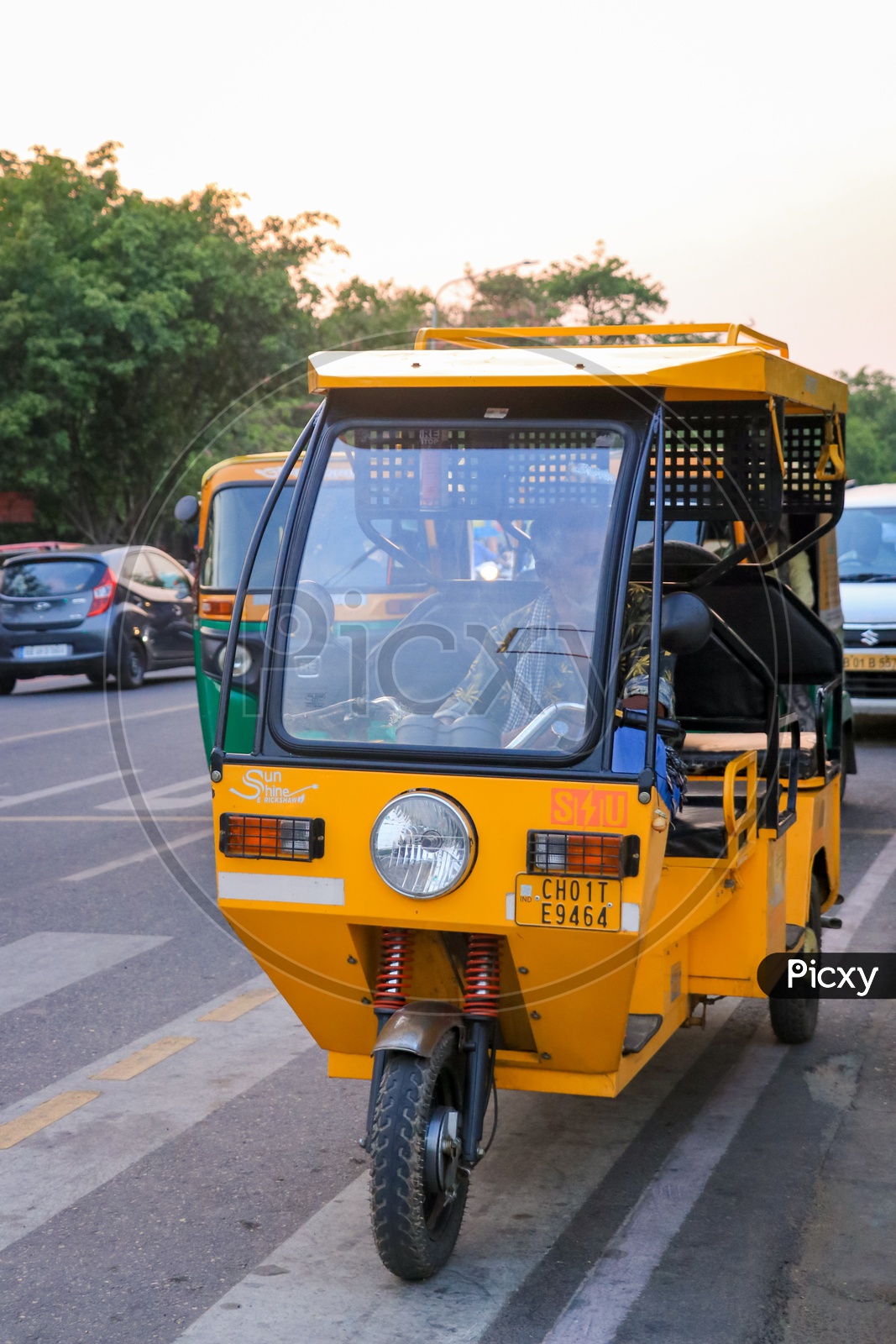 Yellow electric auto rickshaw on the road