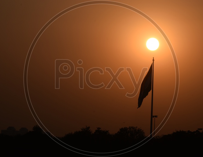 Silhouette Of a Flag Pole  Over a Sunset