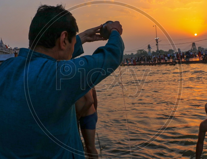 A man doing his early morning rituals at the Ganges river
