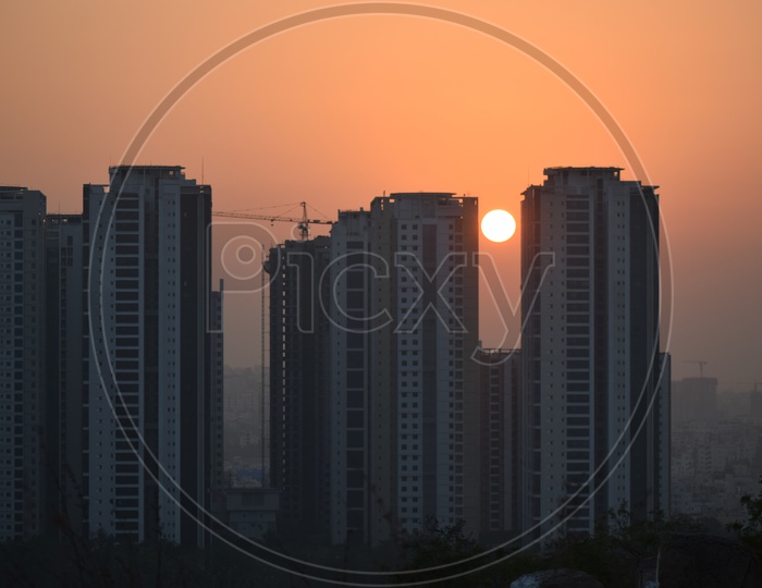 Sunset Over High Rise Construction Buildings