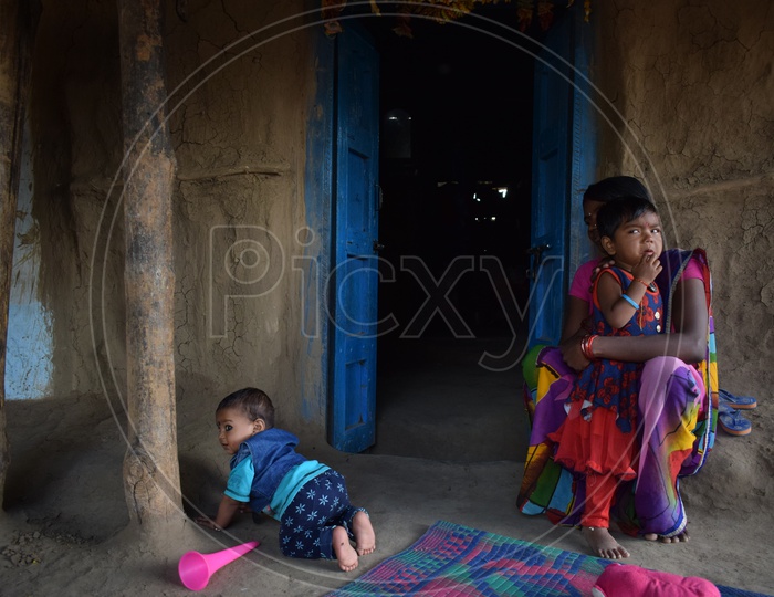 A Small Child And Mother In A  Tribal Village  House
