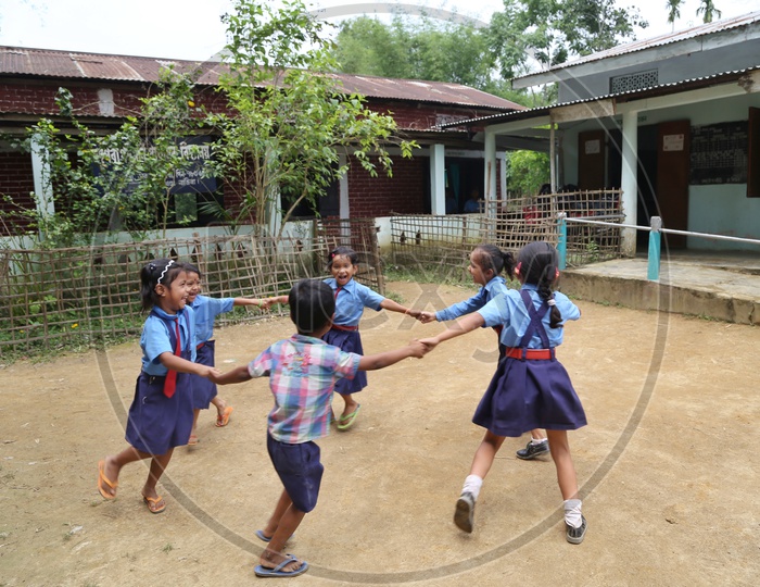 School Students or School Children Wearing School Uniforms And Happily  Playing With  Smile Faces In School Premise